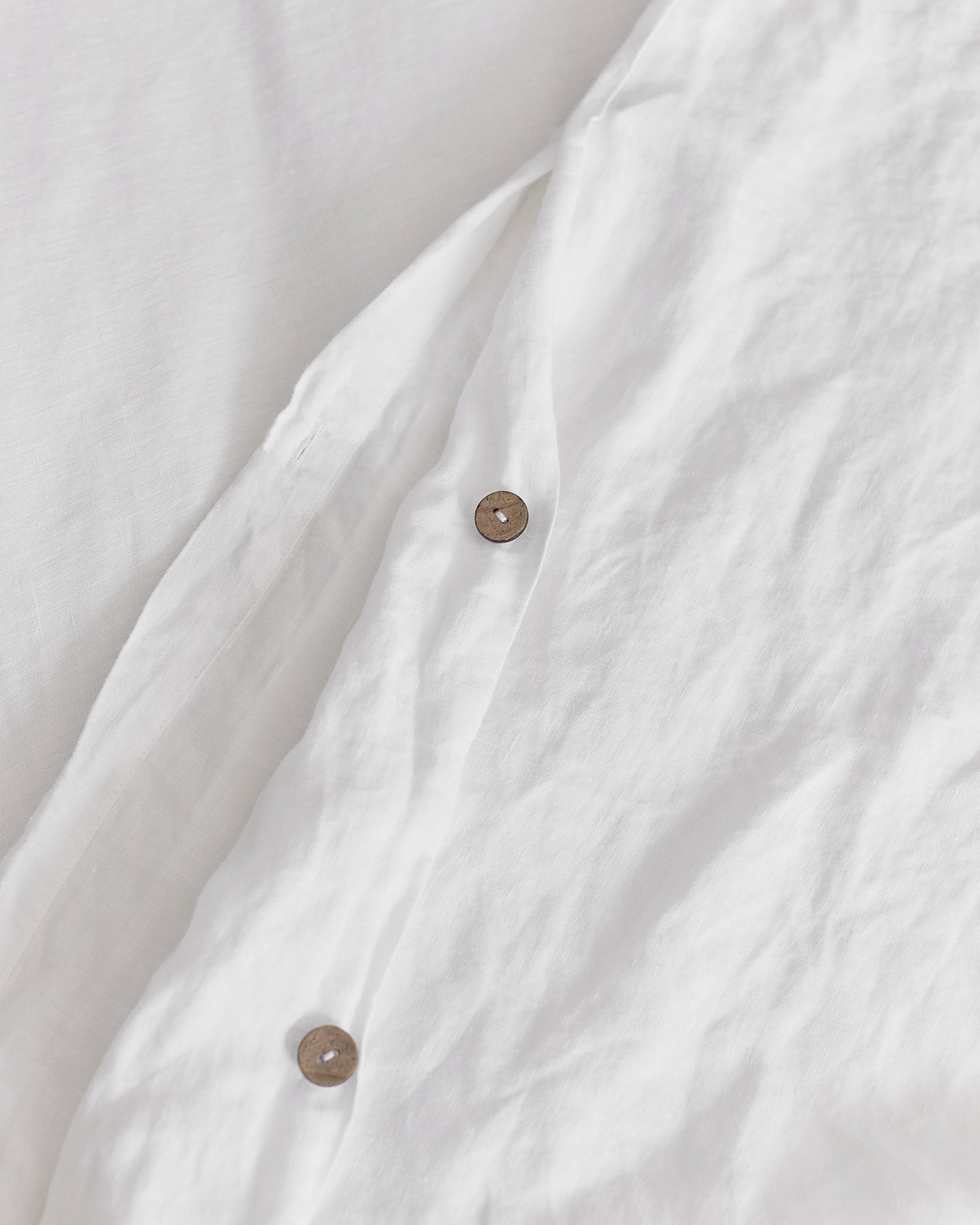 coconut button enclosure of white hemp duvet cover
