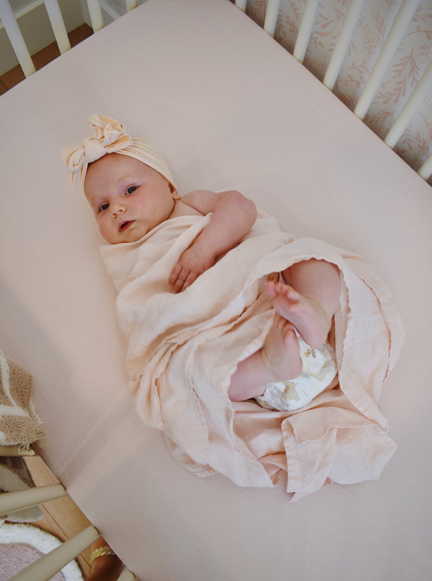 baby light pink crib sheet and swaddle blanket