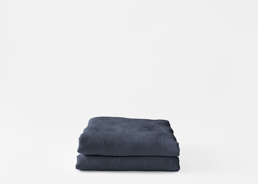 folded hemp pillowcases in a muted navy color