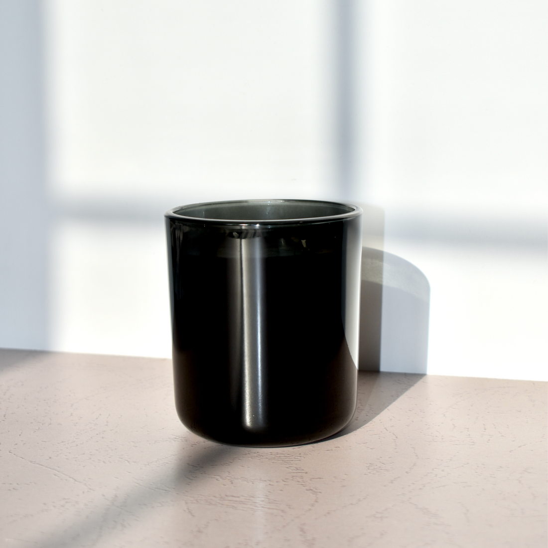 candle in black glass vessel. luxury fragrance.