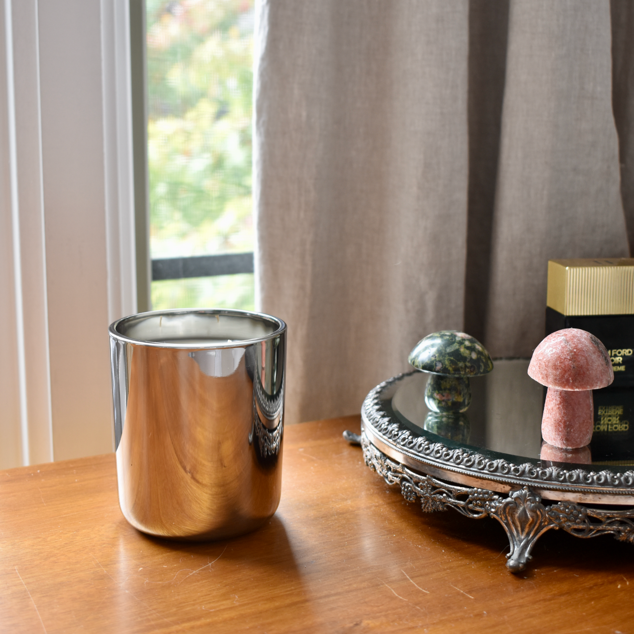 metallic gunmetal vessel displayed on a dresser 